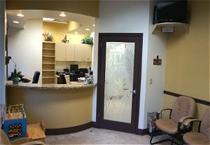 Interior photo of dentist office waiting room and front desk